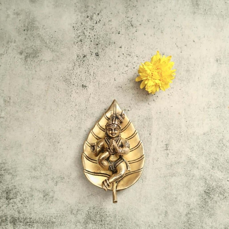 Brass Bala Gopala Krishna on Peepal Leaf Wall Hanging - 6 inch Height | Adorable Brass Wall Hanging of Bala Gopala Krishna on Peepal Leaf Brass Bala Gopala Krishna on Peepal Leaf Wall Hanging - 6 inch Height | Adorable Brass Wall Hanging of Bala Gopala Krishna on Peepal Leaf